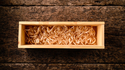 Open wooden box for vine filled with shreded paper