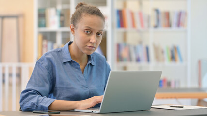 Attractive African Woman with Laptop Looking at Camera