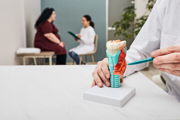 Thyroid gland check-up. Doctor examining overweight woman's enlarged thyroid, tumor thyroid