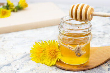 Dandelion honey in a jar and fresh flowers, 
beautiful composition