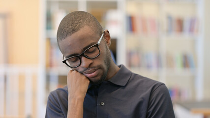 Portrait of Tired Young African Man taking Nap