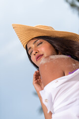 woman posing with her sun hat