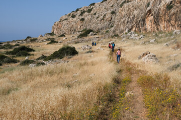 Group of unrecognised people hiking in nature on a trail. Healthy lifestyle walking outdoors