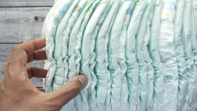 stack of baby diaper on table,
