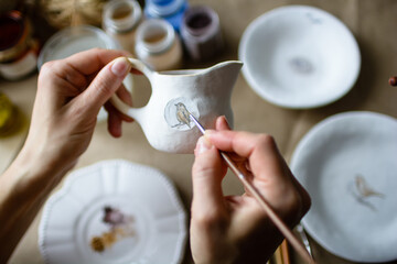 Fototapeta na wymiar Hand-painting homemade ceramic dishes.