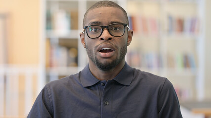 Portrait of Upset Young African Man feeling Shocked