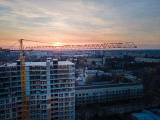 aerial view of apartment construction site with crane
