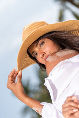 woman posing with her sun hat