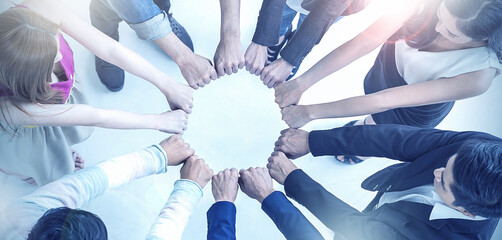 Multicultural hands synergy brainstorm business man woman in circle top view background. Support...