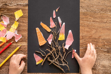 Bonfire for Jewish holiday Lag BaOmer and hands of child on wooden background.