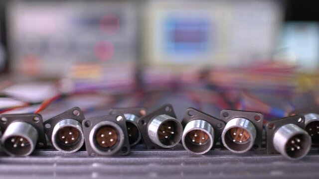 Slider shot video of blurry metal sockets for plugs are in a heap. Concept for the production of computer televisions and audio speakers