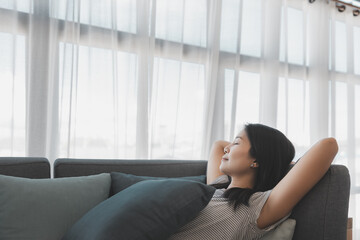 Asian woman relax and sleep on sofa at home