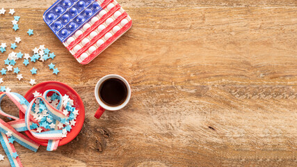 Cup of coffee, American flag, candies on wooden background with copy space. Independence Day, 4th...