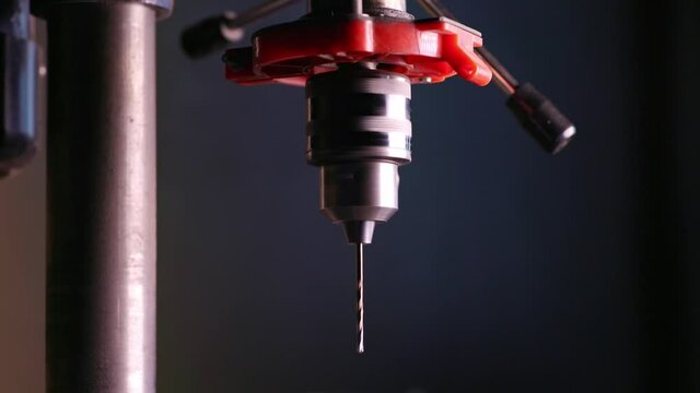 Slider pan shot of a drilling machine rotation at the workplace of a toolman locksmith
