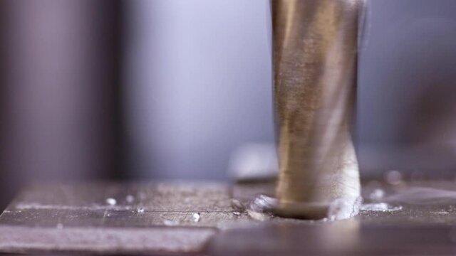Shot of a drilling machine rotation at the workplace of a toolman locksmith, UHD 4k macro video
