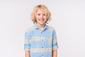 Happy caucasian preteen boy with toothy smile in casual clothes isolated in white