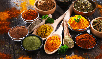 Fototapeta premium Variety of spices on wooden kitchen table.