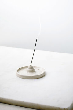 Fuming incense stick in craft ceramic holder