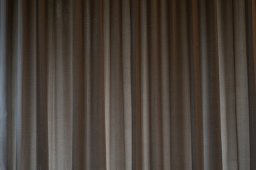 Obraz premium Covered curtains with light brown creases.