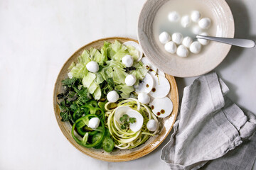 Fototapeta na wymiar Green raw vegetables and herbs for salad