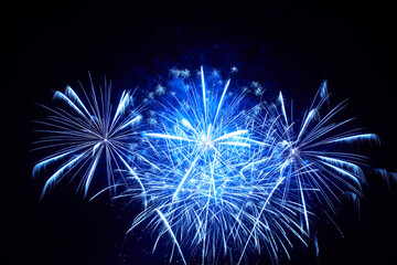 Blue holiday fireworks on night sky