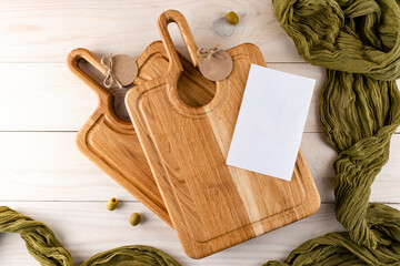 Empty wooden cutting board with olives with copy space
