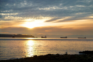Fototapeta na wymiar Sunset on sea. Landscape with ships on sunset sea