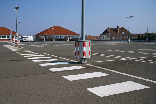 Pedestrian zebra crossing in an empty parking lot on the roof of a supermarket.