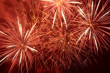 Red holiday fireworks on night sky