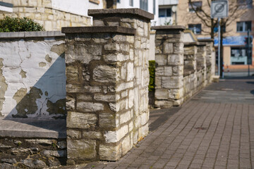 Hewn stone fence in front of the house.