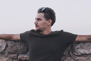 Serious sight under a sunglasses of old fashioned curly man with anchor beard. A view full of resolve and duty © Nik Viatkin