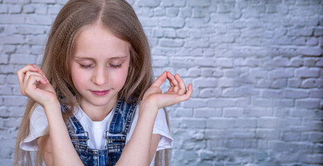 Girl with closed eyes show fingers as meditation
