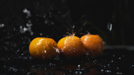 Fototapeta na wymiar Orange fruit was wet with water splash,
