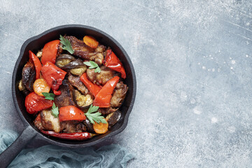 Pork with grilled vegetable stir fry on pan with copy space