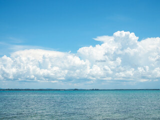 Naklejka na ściany i meble Beautiful blue sea Against the sky and white clouds.