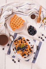 Waffles with blueberries and chocolate cream.
