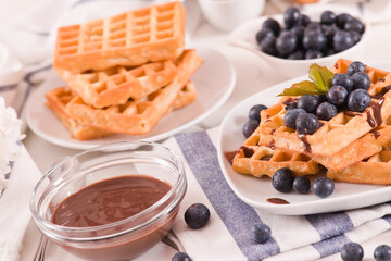 Waffles with blueberries and chocolate cream.
