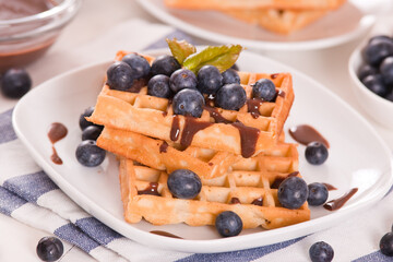 Waffles with blueberries and chocolate cream.
