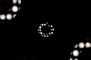 Optical art black and white theme of geometric round shapes (monochrome). Donut form, partial abstract polka dot effect and stylized modern minimalistic graphic design with space for text, copy space.