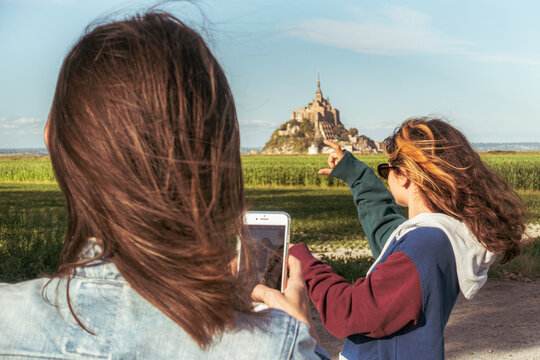Female tourists taking photos of Mont Saint-Michel