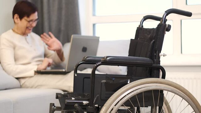 Handicapped woman with lapot lay on couch