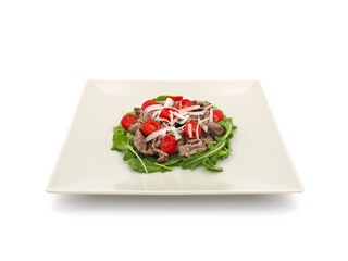 Beef strips with rucola and tomatoes isolated on white background