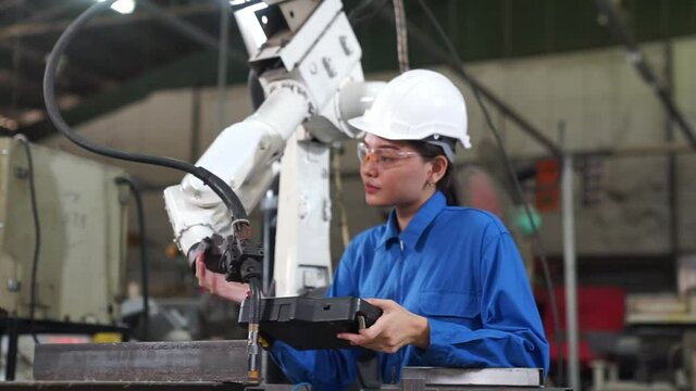 Engineer check and control welding robotics automatic arms machine in intelligent factory industrial.