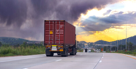 Truck on highway road with red container, transportation concept.,import,export logistic industrial Transporting Land transport on the expressway with sunrise sky and very cloudy