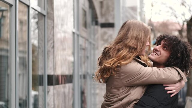 Passionate Young Couple Kissing And Embracing Spinning Around Outdoor In The City