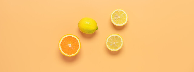 Banner with fresh orange and lemon on a pastel yellow background. Top view, flat lay.