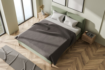 Green and wooden bedroom interior with bed and linens, top view, mockup posters