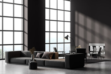 Corner view of contemporary dark grey living room interior with fireplace, sofa and armchairs. Wall...