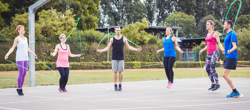 Group of man and woman skipping rope