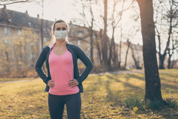 Fit woman during health crisis exercising outdoors wearing mask
